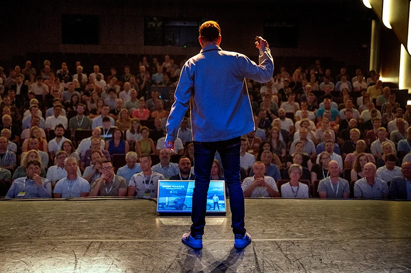 Wiebe Wakker as motivational speaker giving a presentation in a theatre.