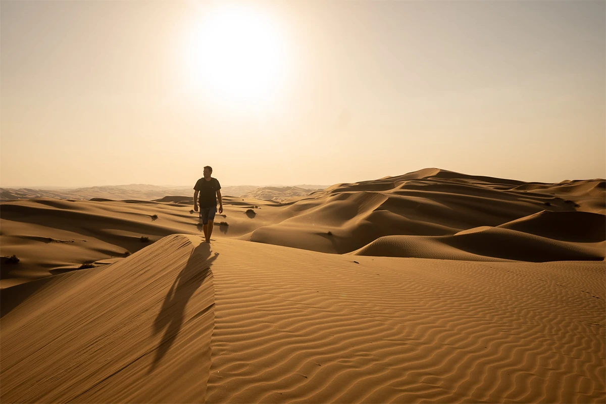 Wiebe Wakker in de woestijn Wiebe Wakker loopt door de woestijn tijdens zonsondergang.